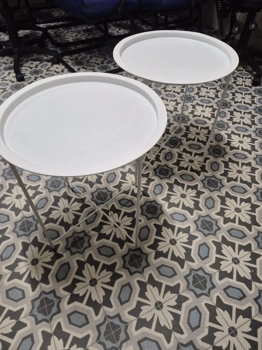 Set of two white round side tables