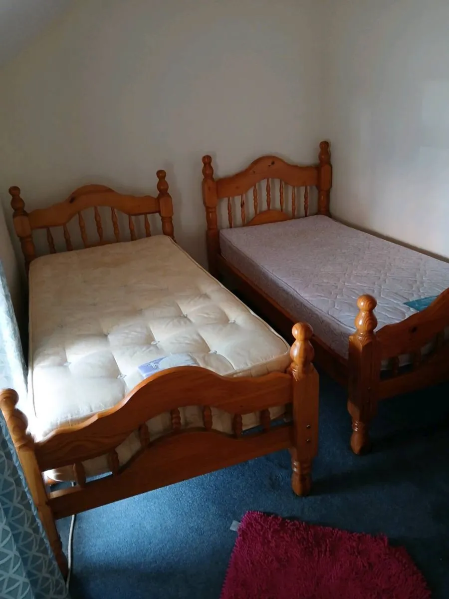 Two wooden matching  single beds with mattresses - Image 1