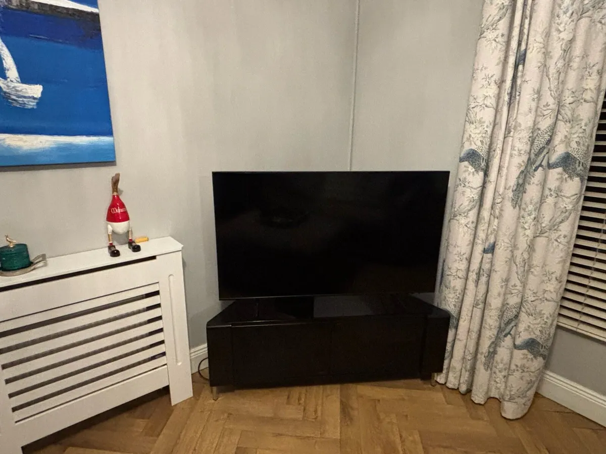 Cornered black glass TV stand