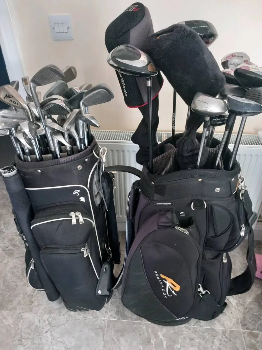A selection of golf clubs and bags. - Image 1