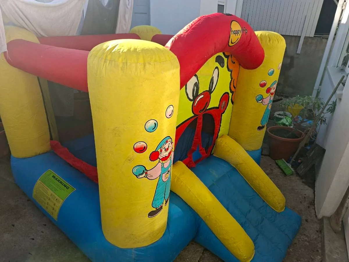 Happy Hop clown-themed bouncy castle with blower - Image 1