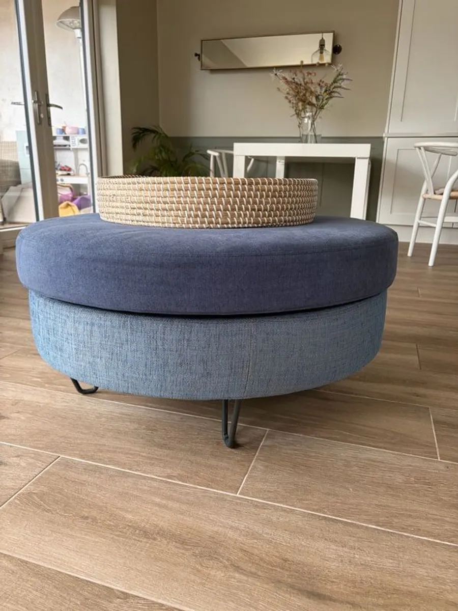 Large Round Blue Ottoman / Footstool with Storage  Stylish round ottoman with a dark denim-blue cushioned top, textured lighter blue base and black metal legs.  The top lifts off to reveal a handy storage space. Perfect as a footstool or styled with a tra - Image 2