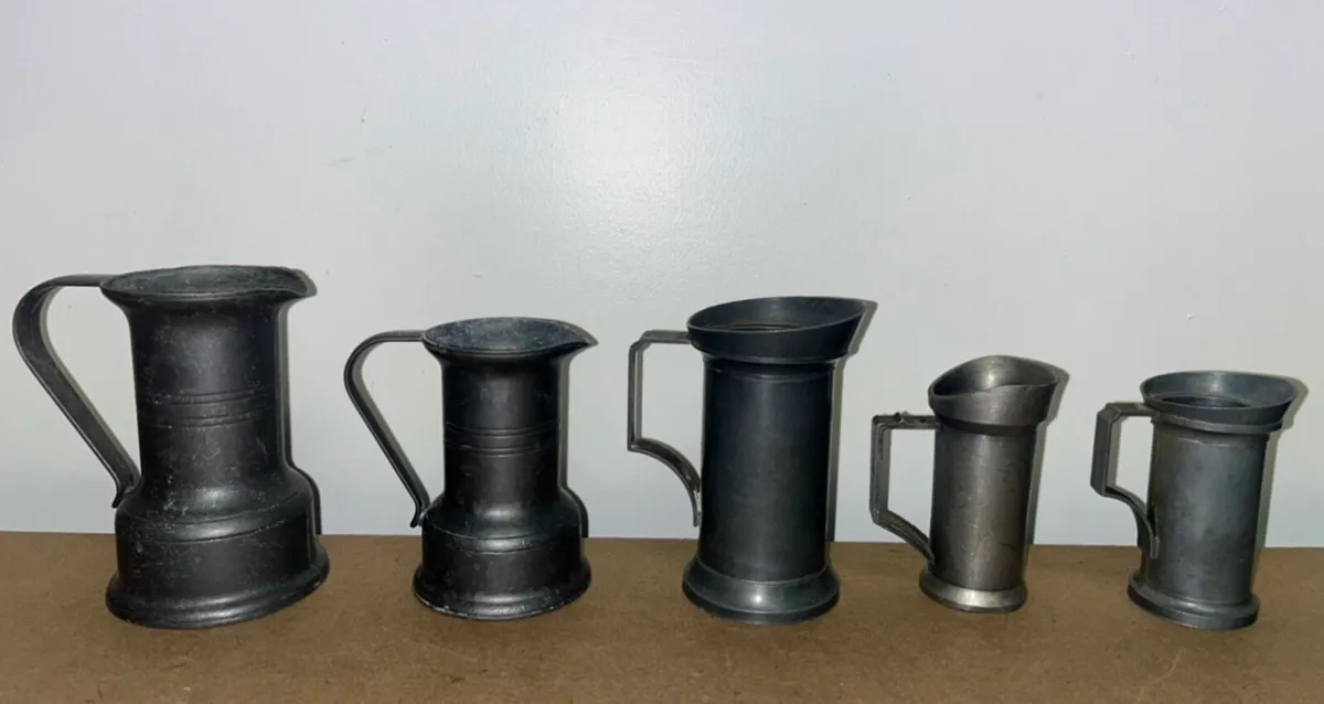 Vintage pewter measuring jugs