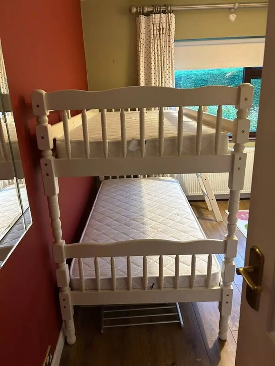 White wooden bunk beds with mattresses - Image 1