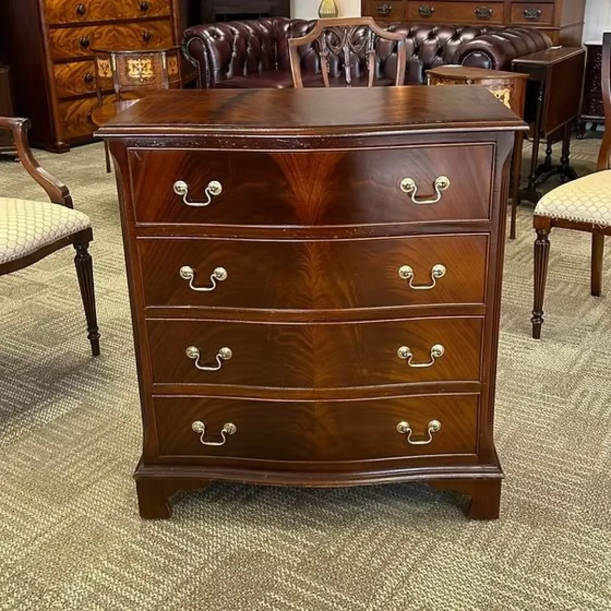 Fabulous serpentine mahogany flamed chest of four