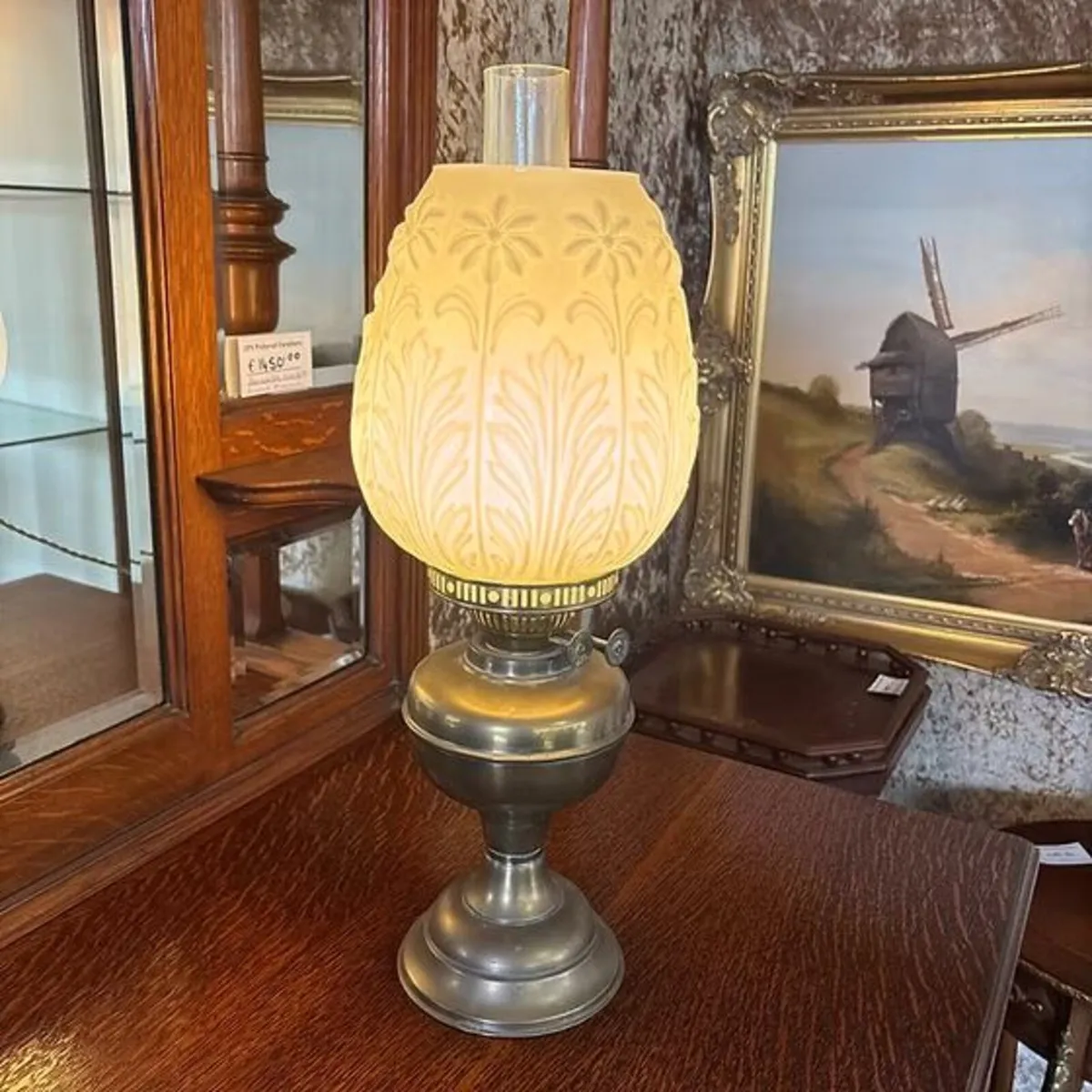 Brass base, embossed milk glass shade with a folia
