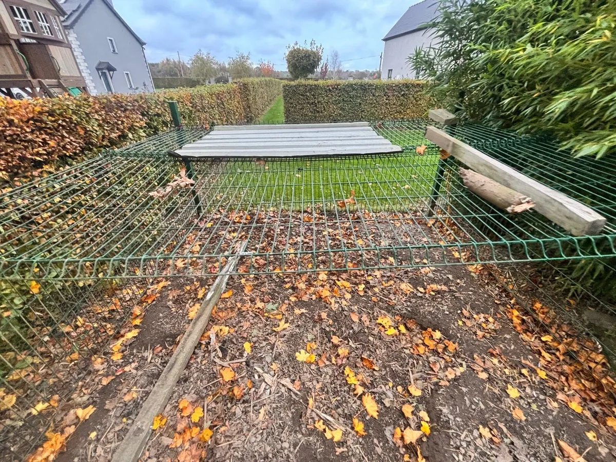 Green fencing and poles - Image 1